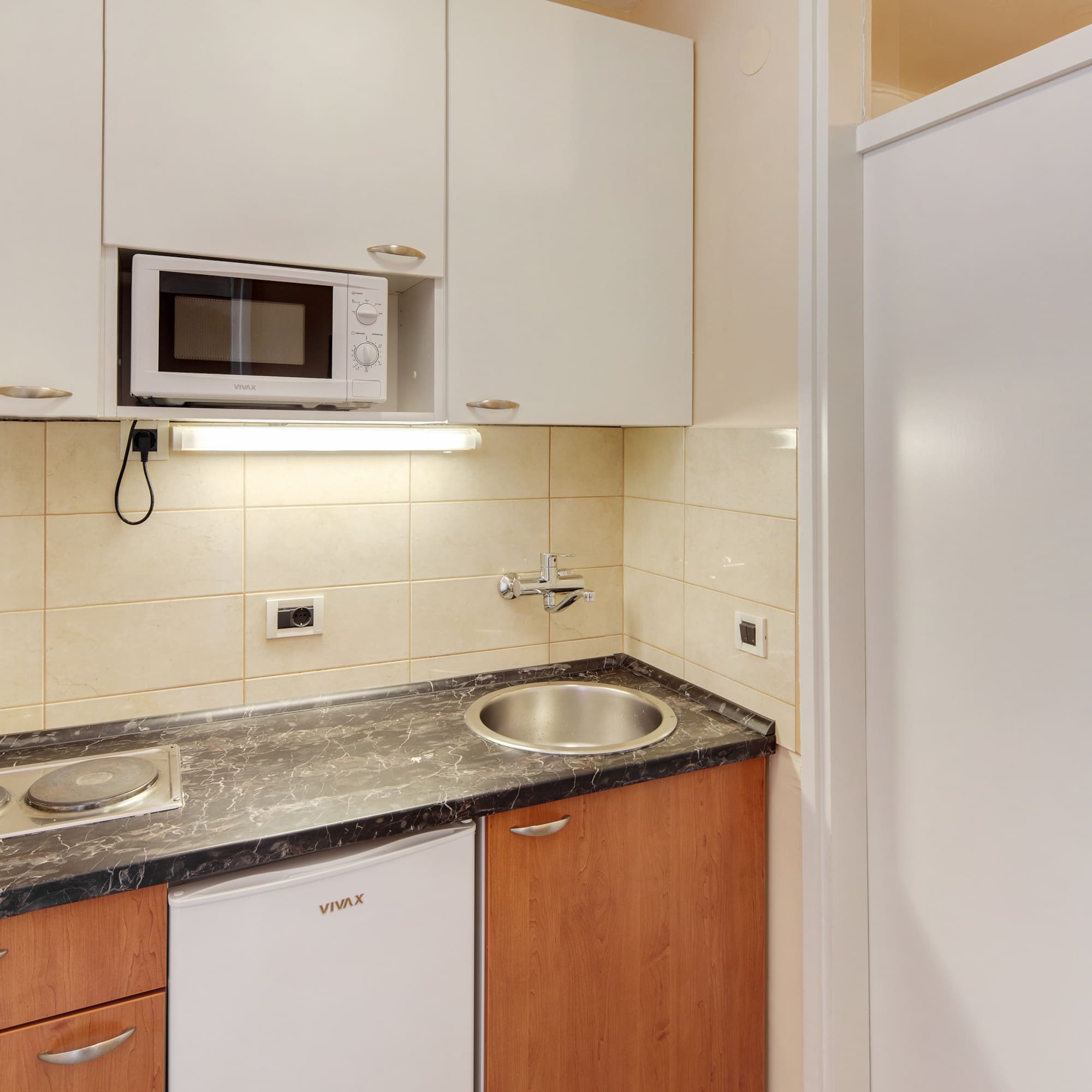 a kitchen with white cabinets and a microwave