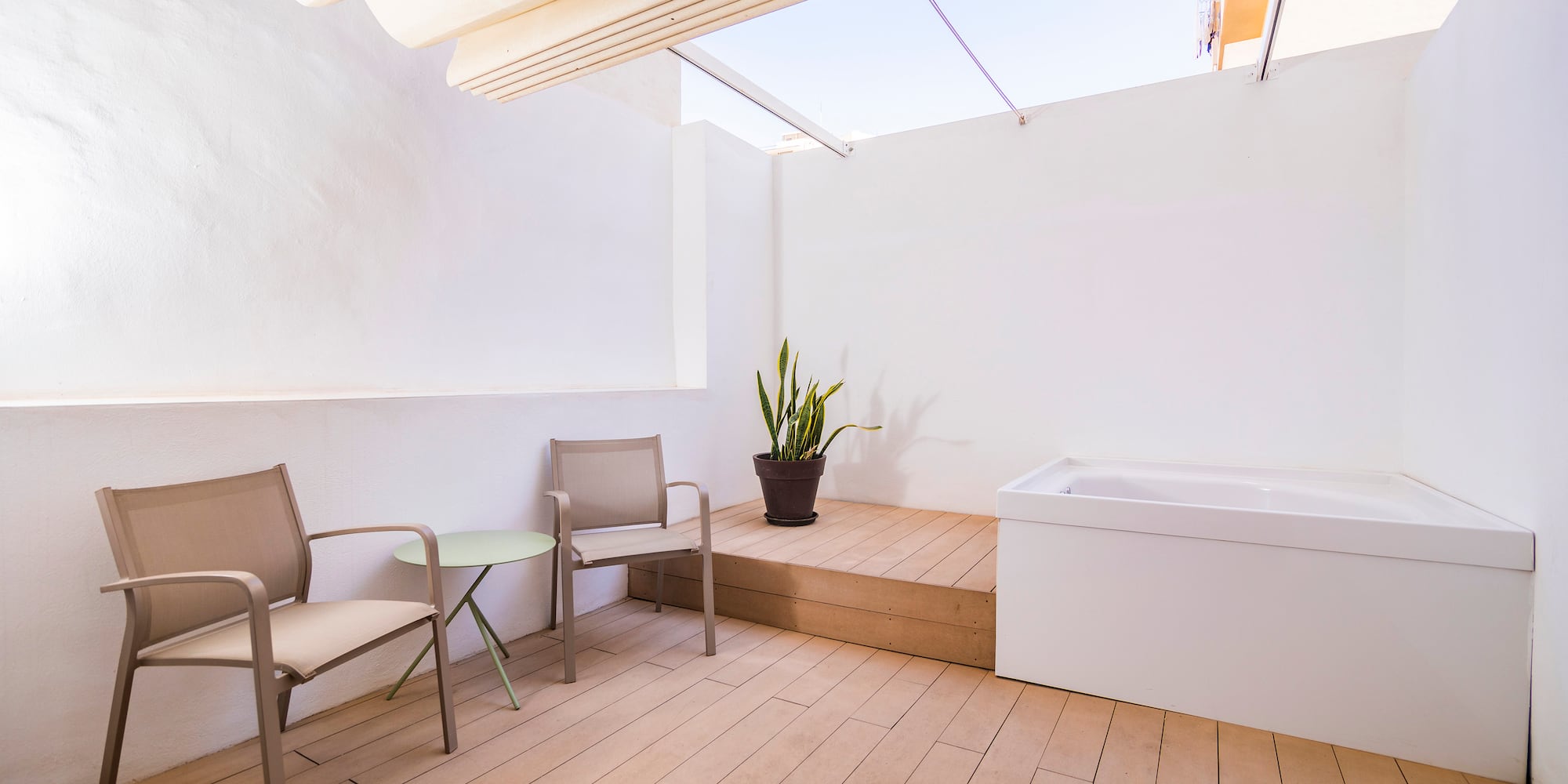 a patio with chairs and a bathtub