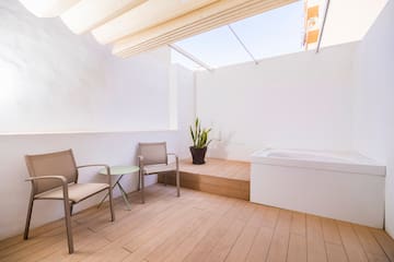 a patio with chairs and a bathtub