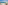 Hotel balcony with ocean view, chairs, table, yachts, and distant island.