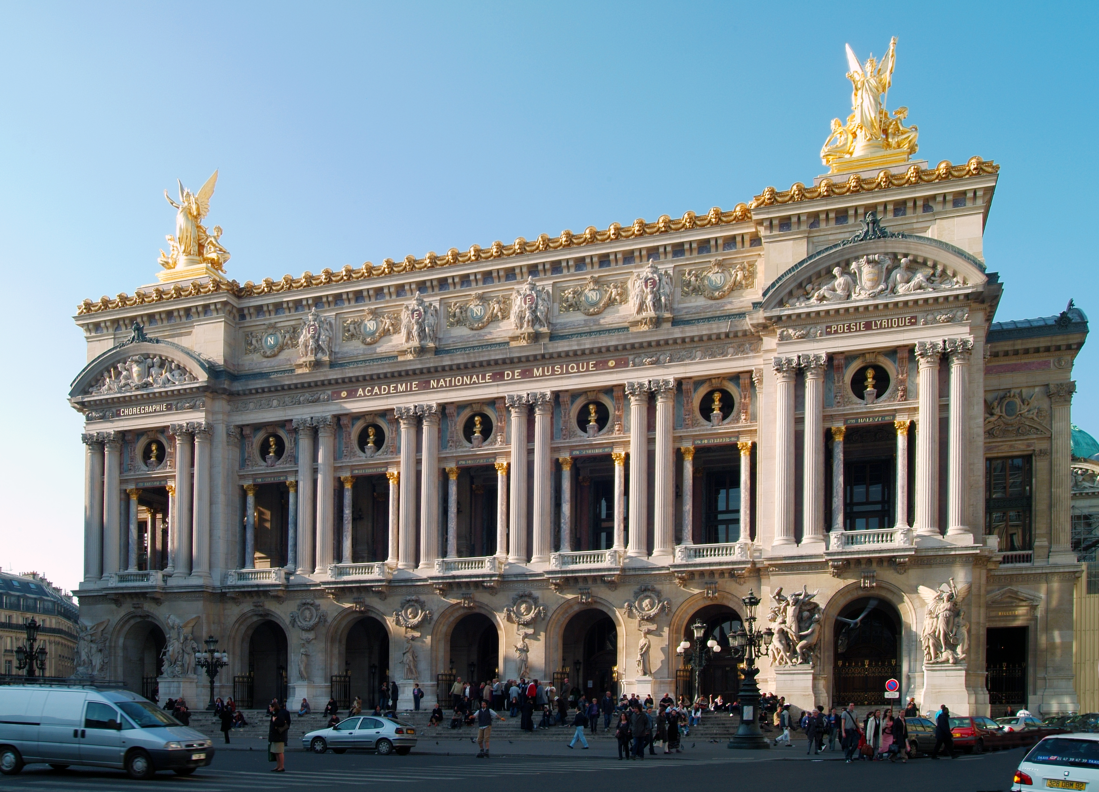 a large building with columns and statues with Palais Garnier in the background