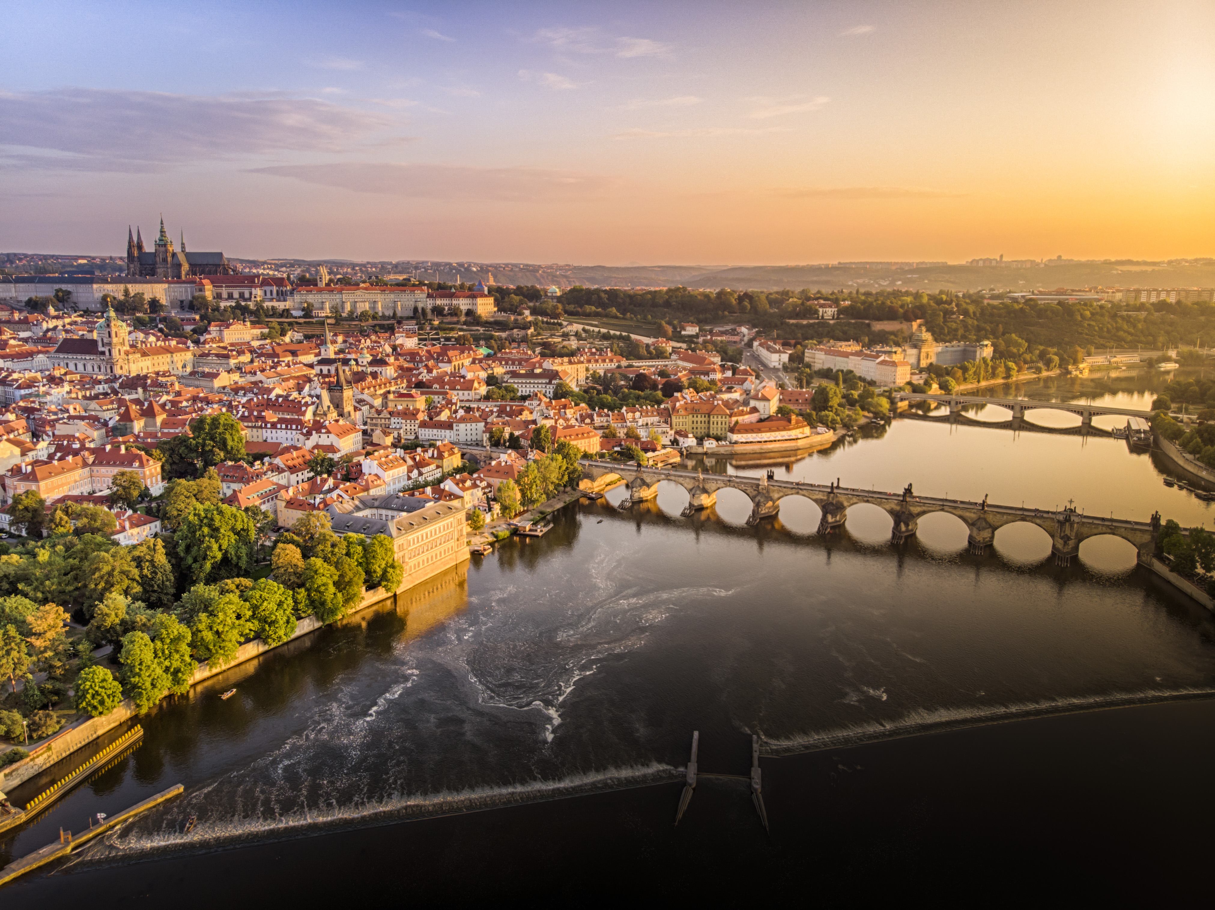 a bridge over a river with a city in the background