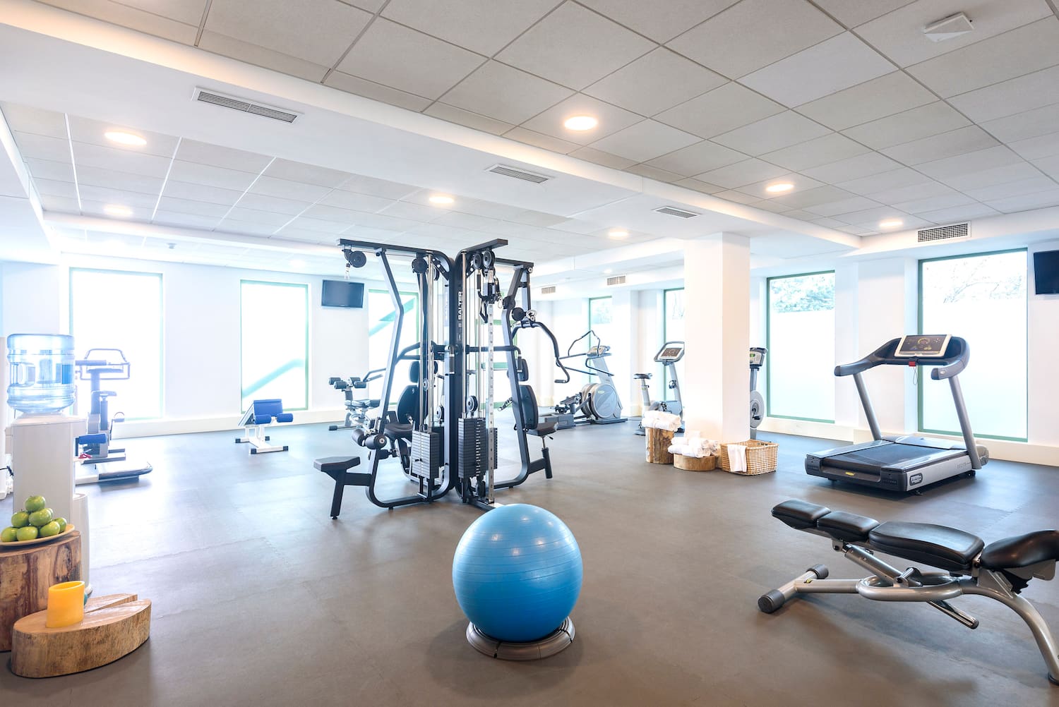 a room with exercise equipment and a ball