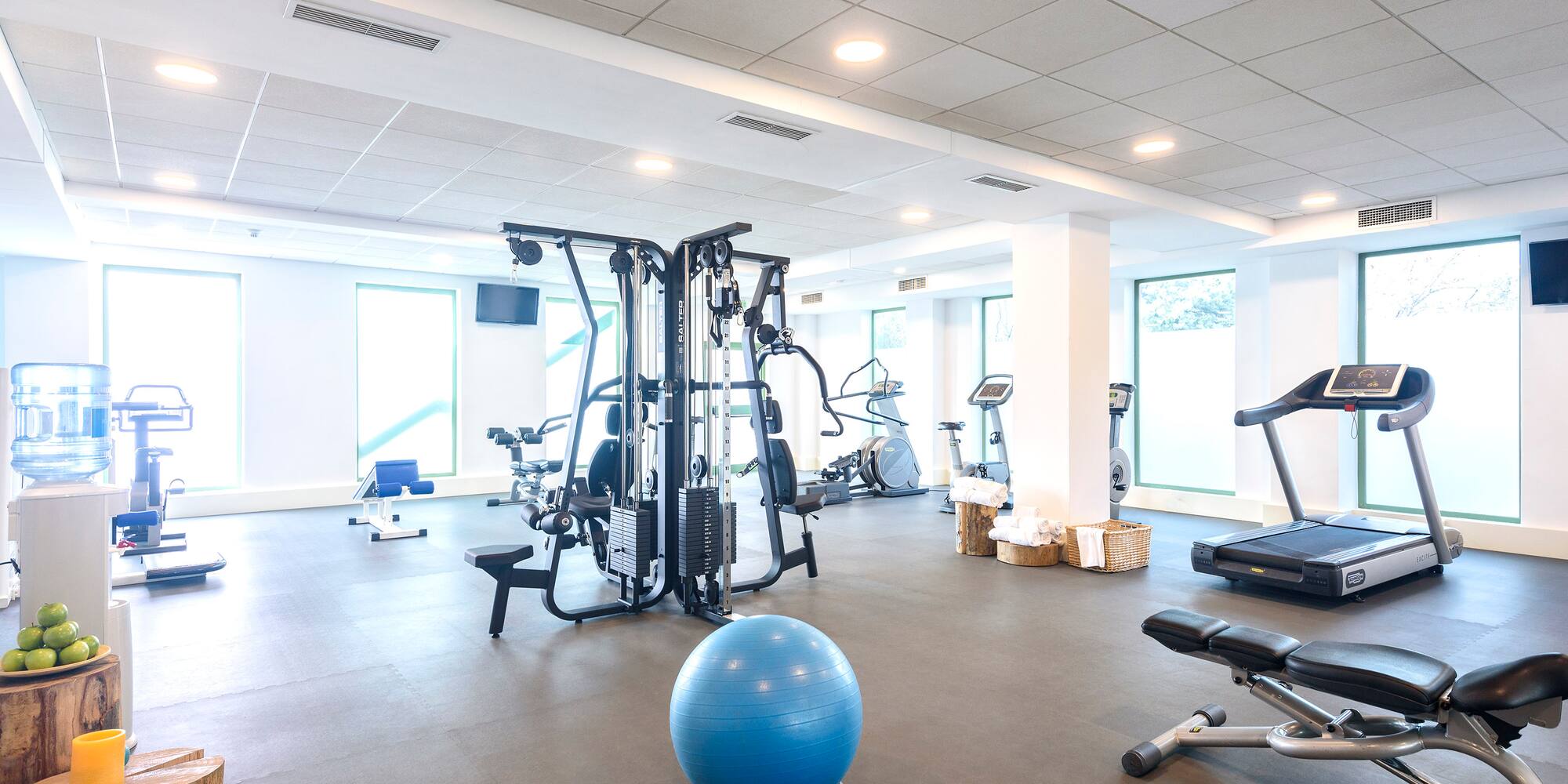 a room with exercise equipment and a ball