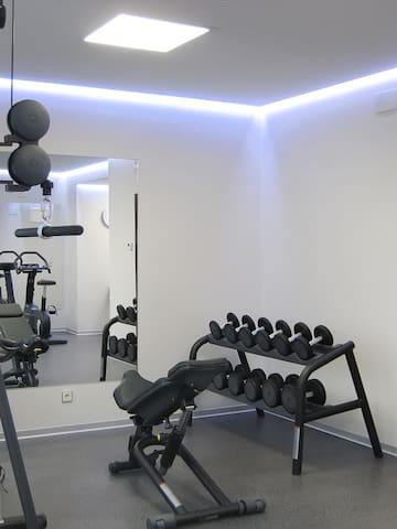 a room with exercise equipment and a mirror