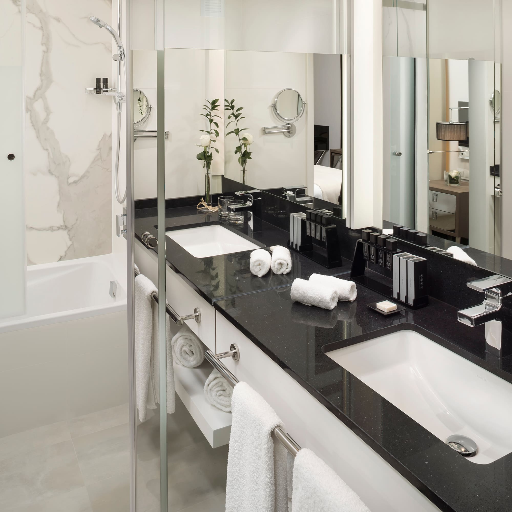 a bathroom with a black countertop and white towels