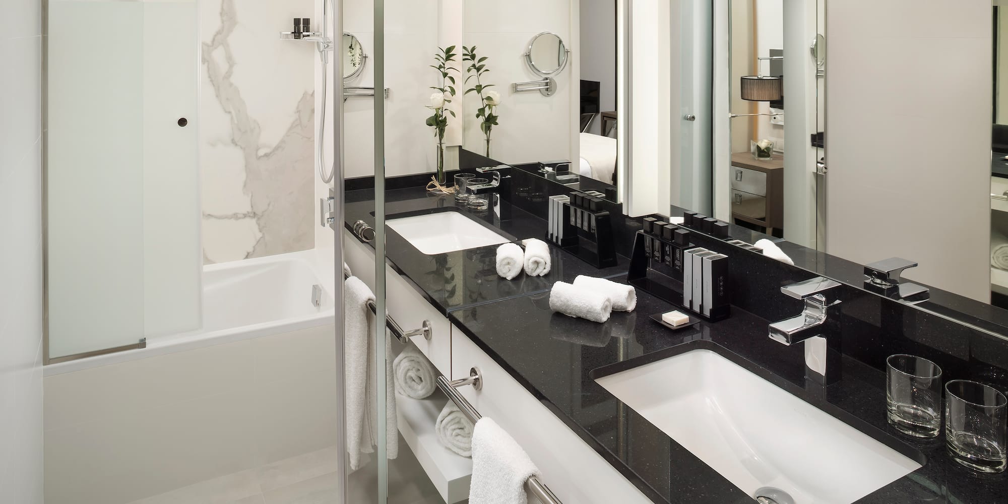 a bathroom with a black countertop and white towels