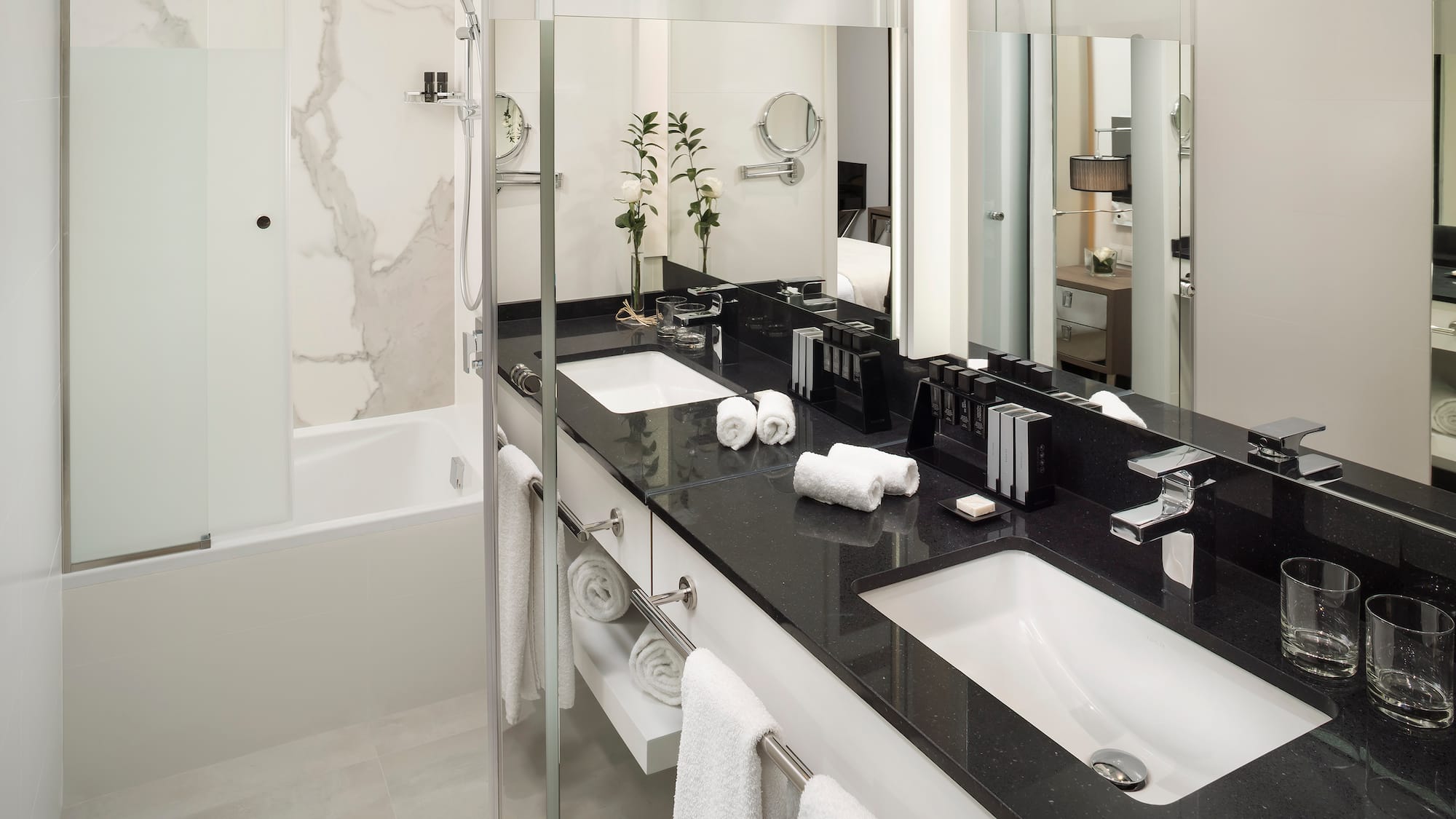 a bathroom with a black countertop and white towels