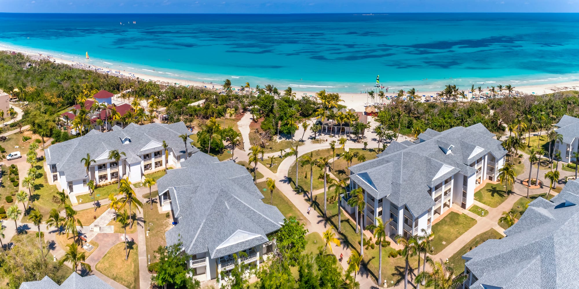 a group of buildings next to a beach