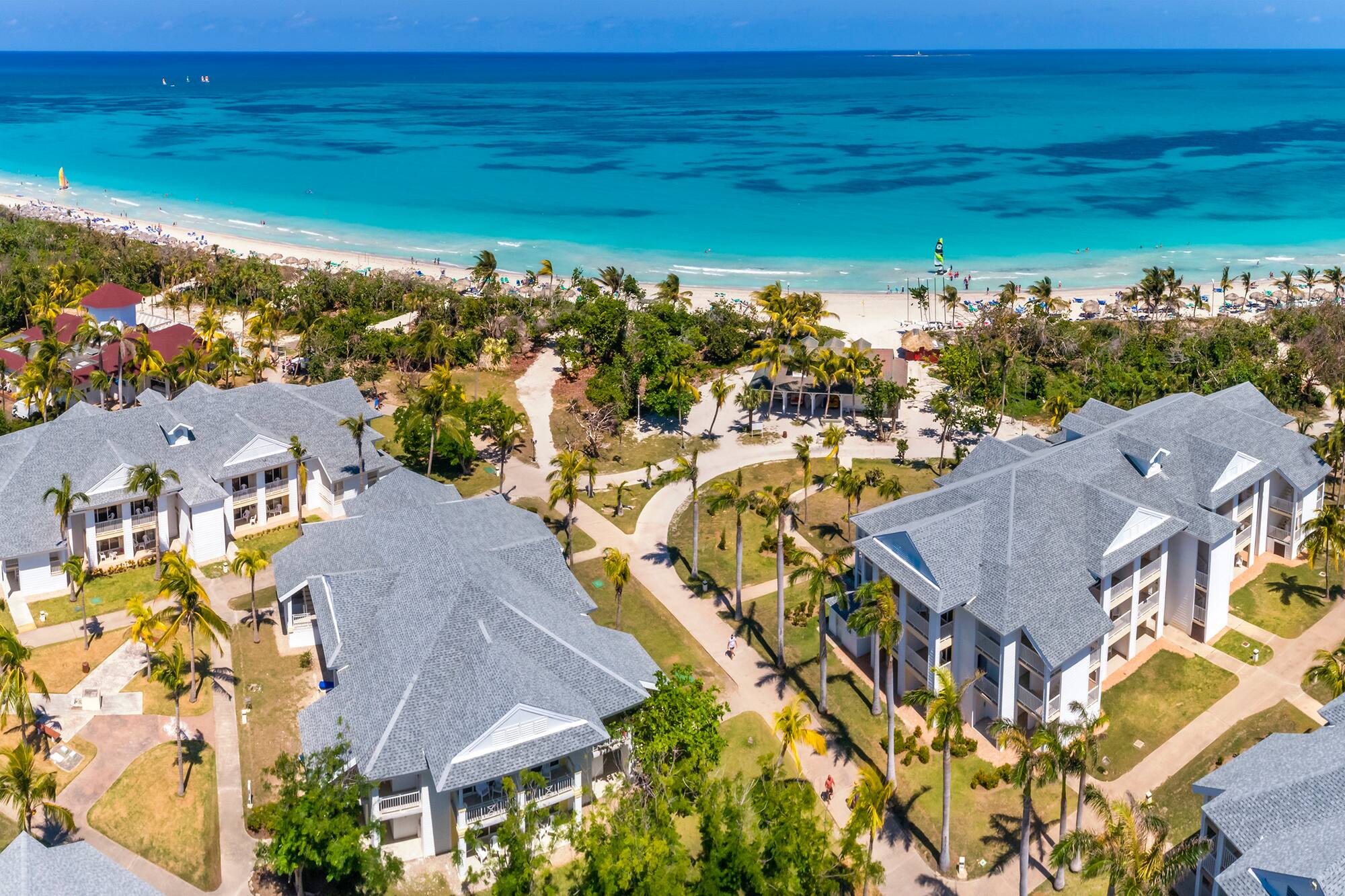 a group of buildings next to a beach