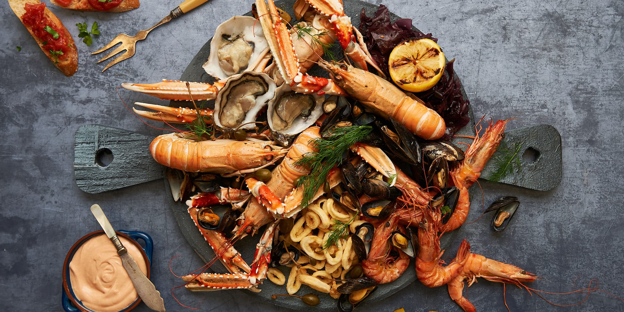 a plate of seafood with a fork and knife