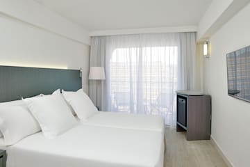 a room with white sheets and a lamp
