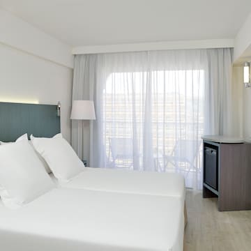 a room with white sheets and a lamp