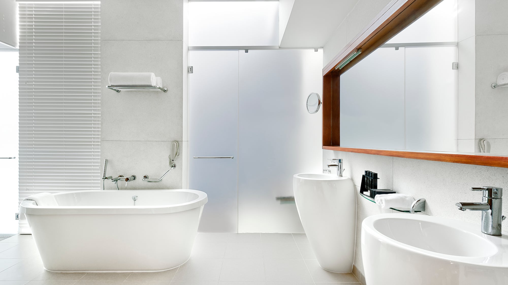 a bathroom with white tub and sink