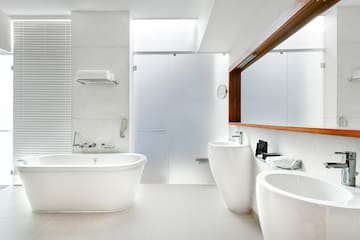 a bathroom with white tub and sink