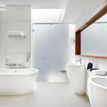 a bathroom with white tub and sink