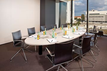 a conference room with a table with chairs and a few bottles of water