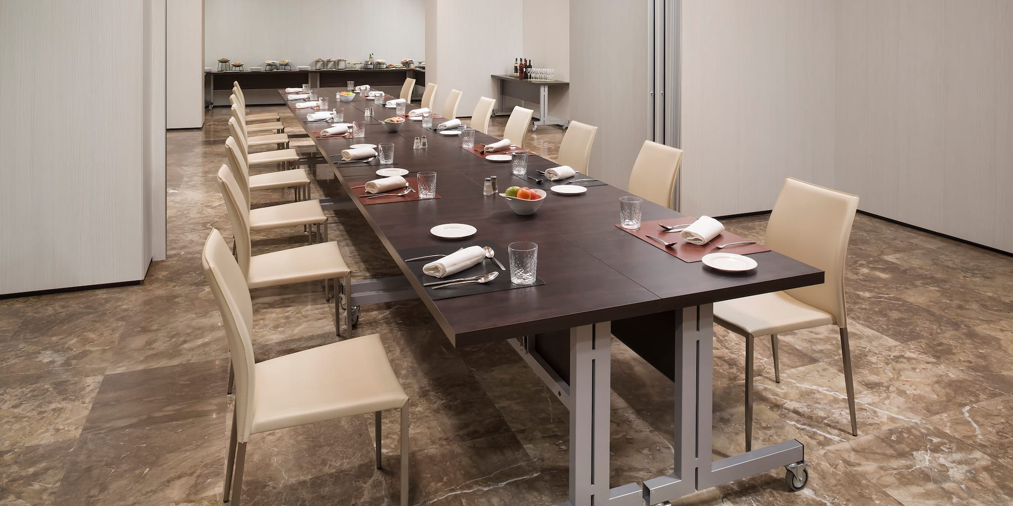 a long table with plates and utensils in a room