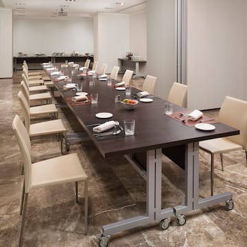 a long table with plates and utensils in a room