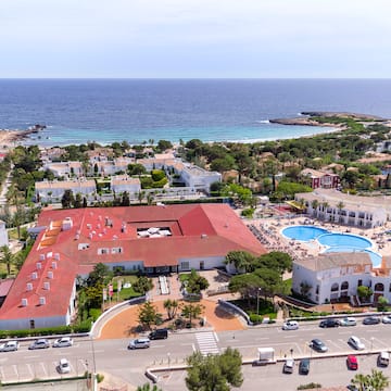 a large building with a pool and a beach