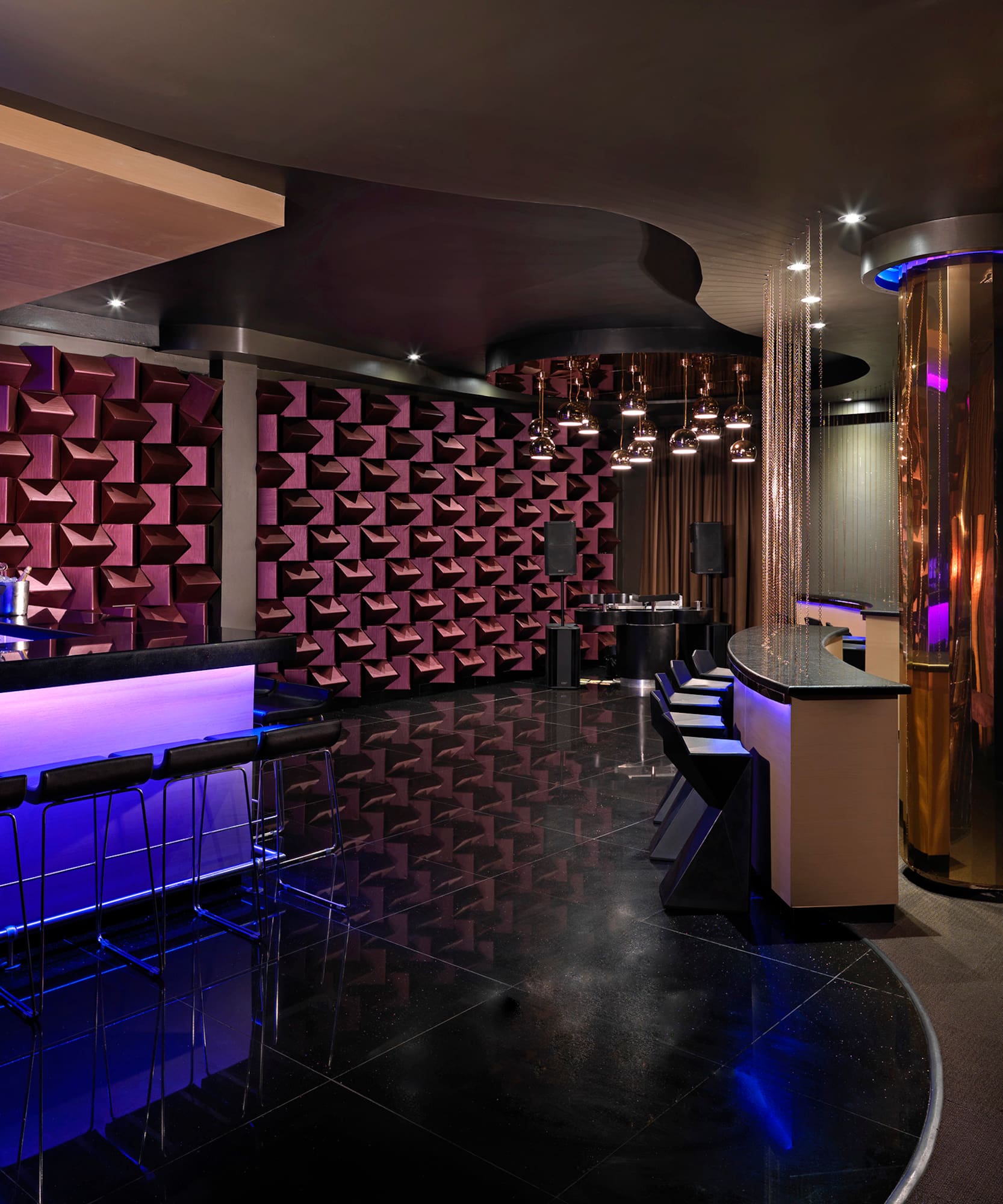 a room with a bar and purple lights