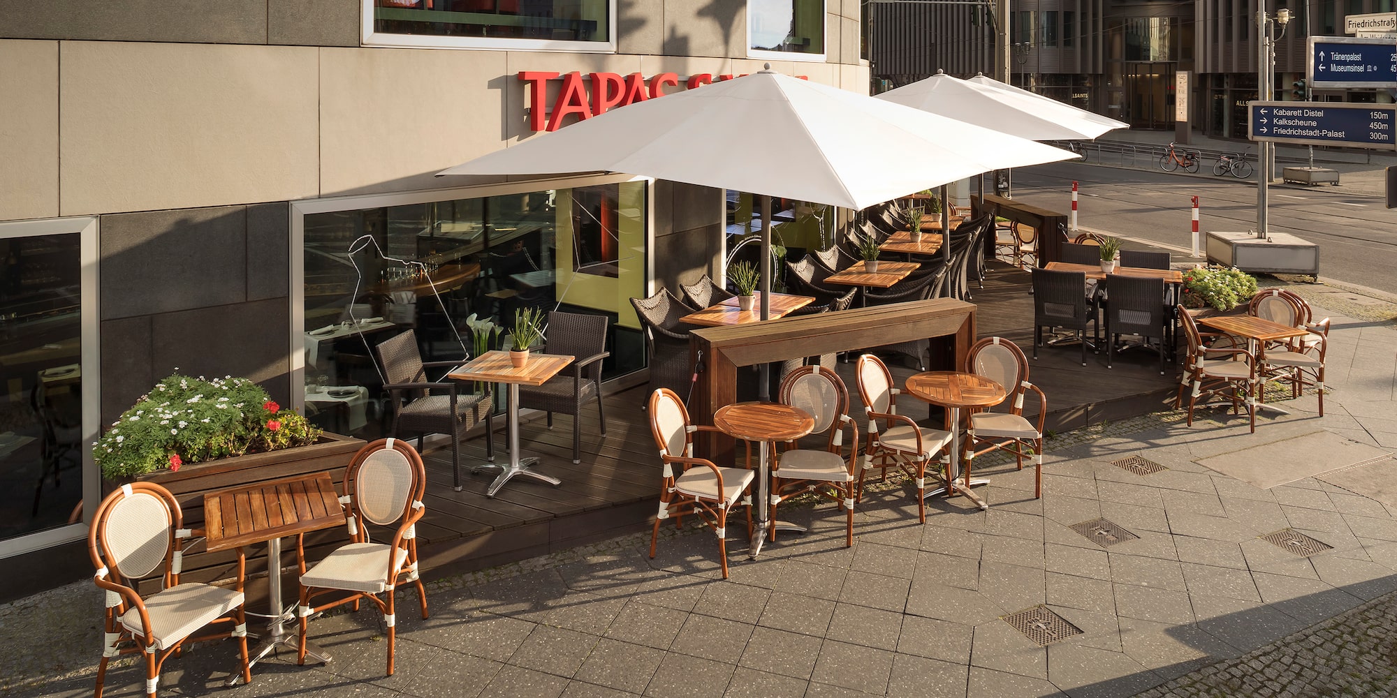 a patio with tables and chairs outside of a building