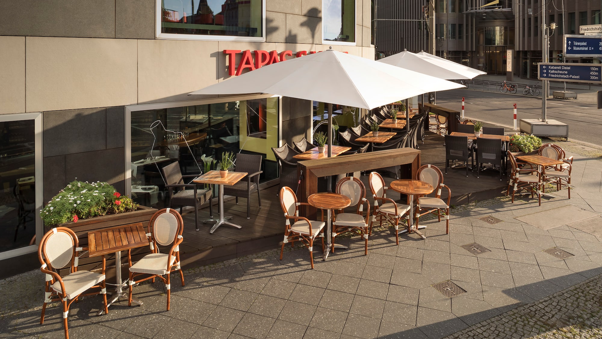 a patio with tables and chairs outside of a building