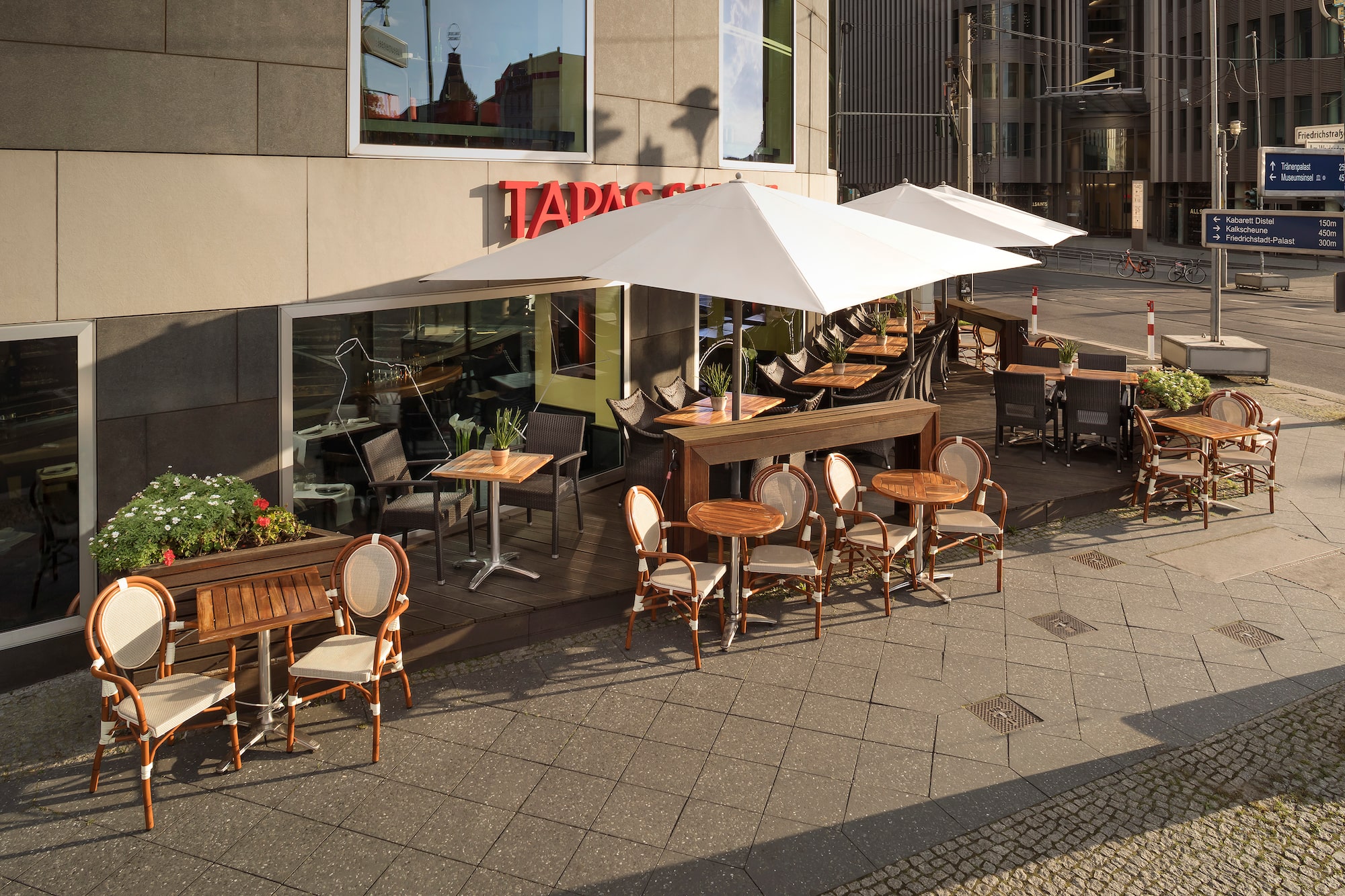 a patio with tables and chairs outside of a building