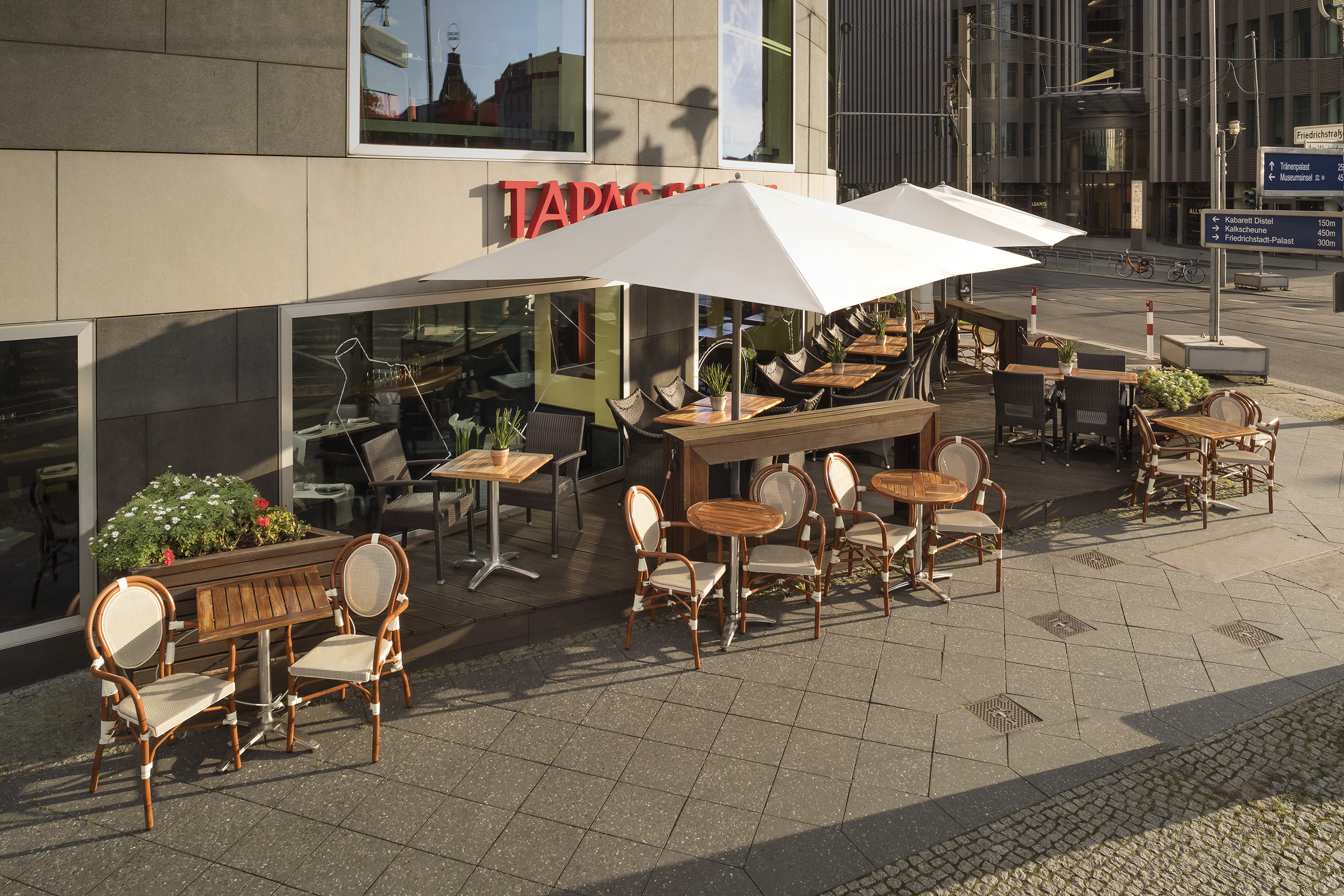 a patio with tables and chairs outside of a building