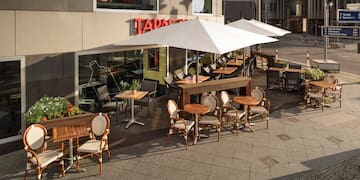 a patio with tables and chairs outside of a building