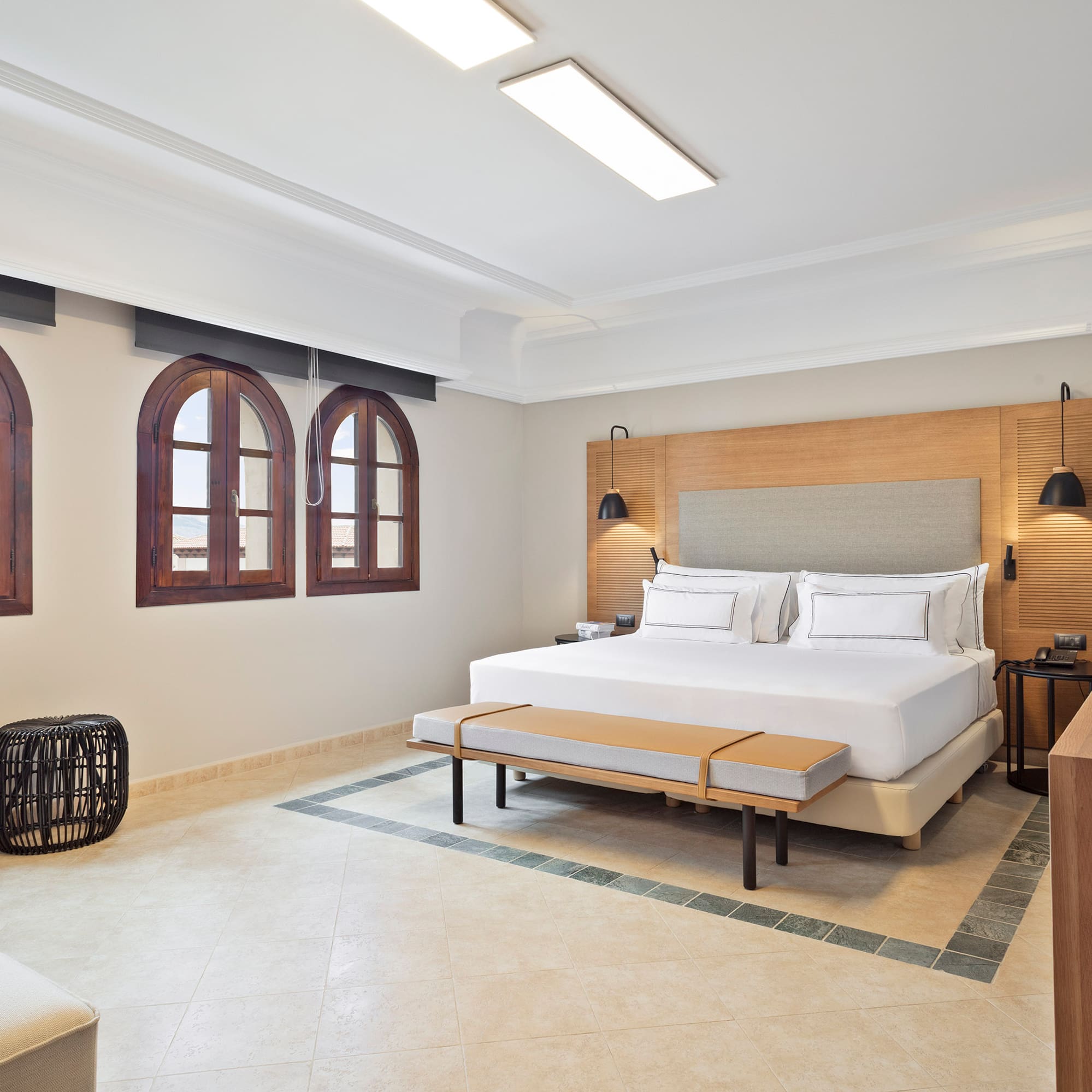 a room with a bed and a bench