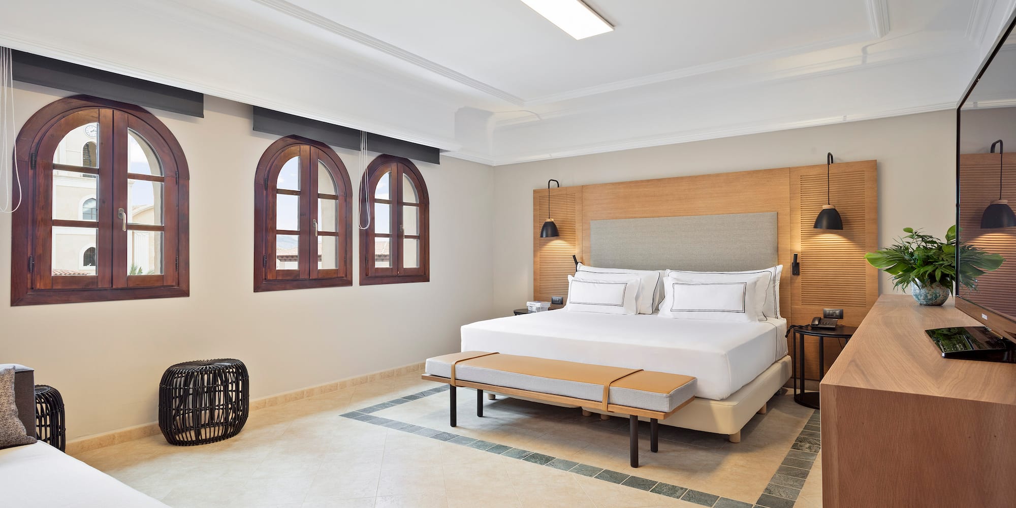 a room with a bed and a bench