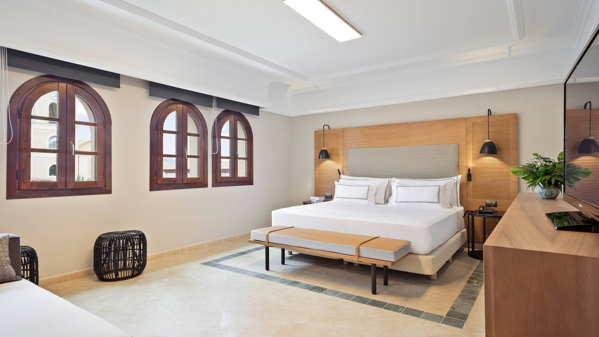 a room with a bed and a bench