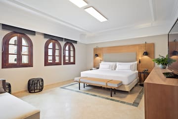 a room with a bed and a bench