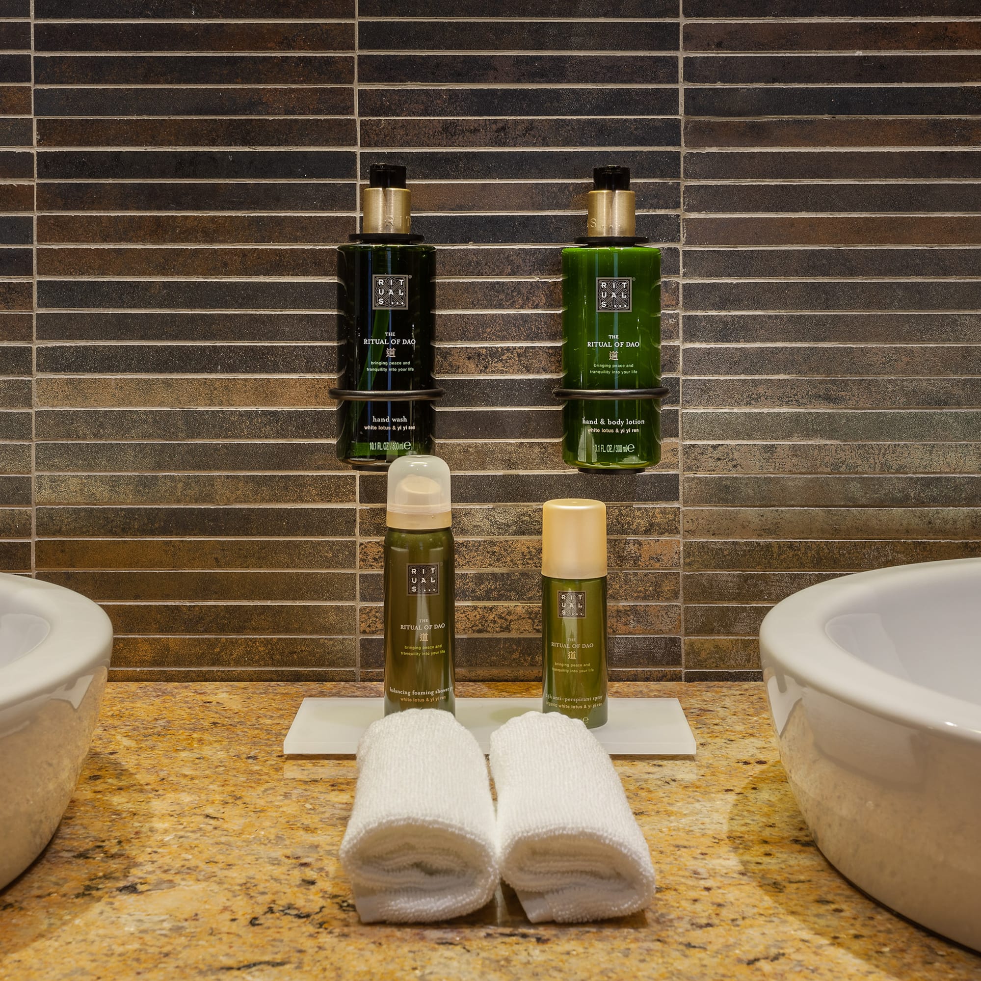 a bathroom with two sinks and two bottles of shampoo