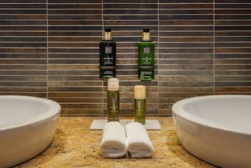 a bathroom with two sinks and two bottles of shampoo