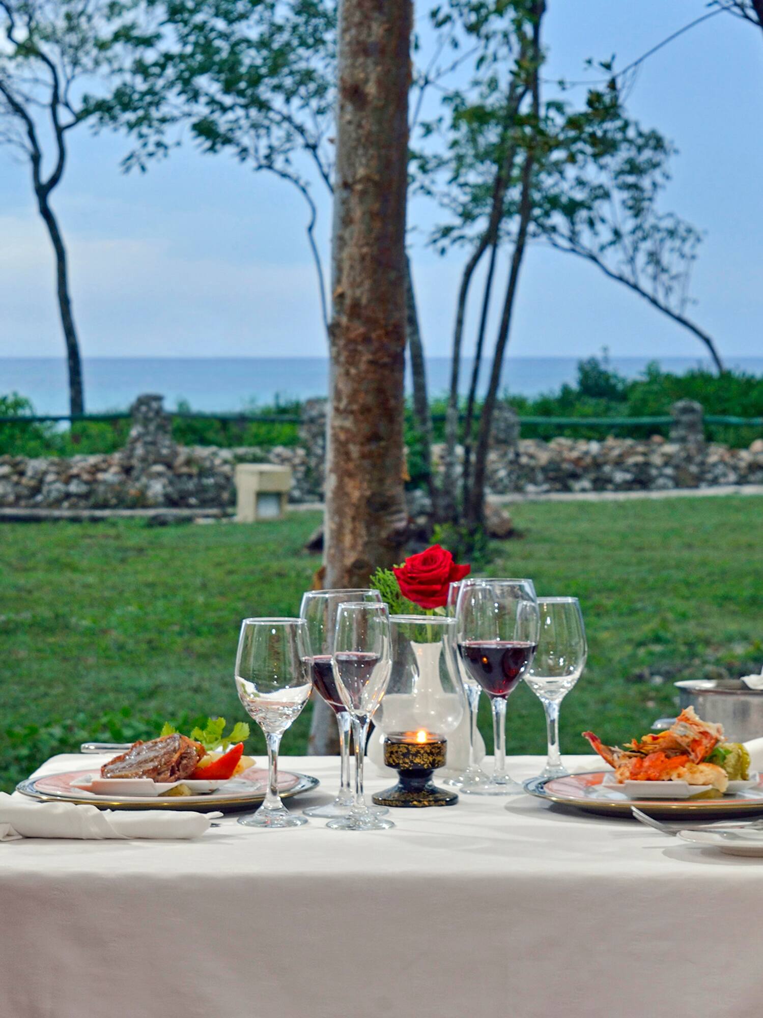 a table with food and wine glasses on it