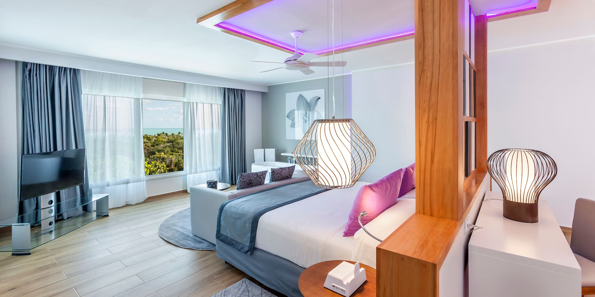 a bedroom with a large bed and a ceiling fan