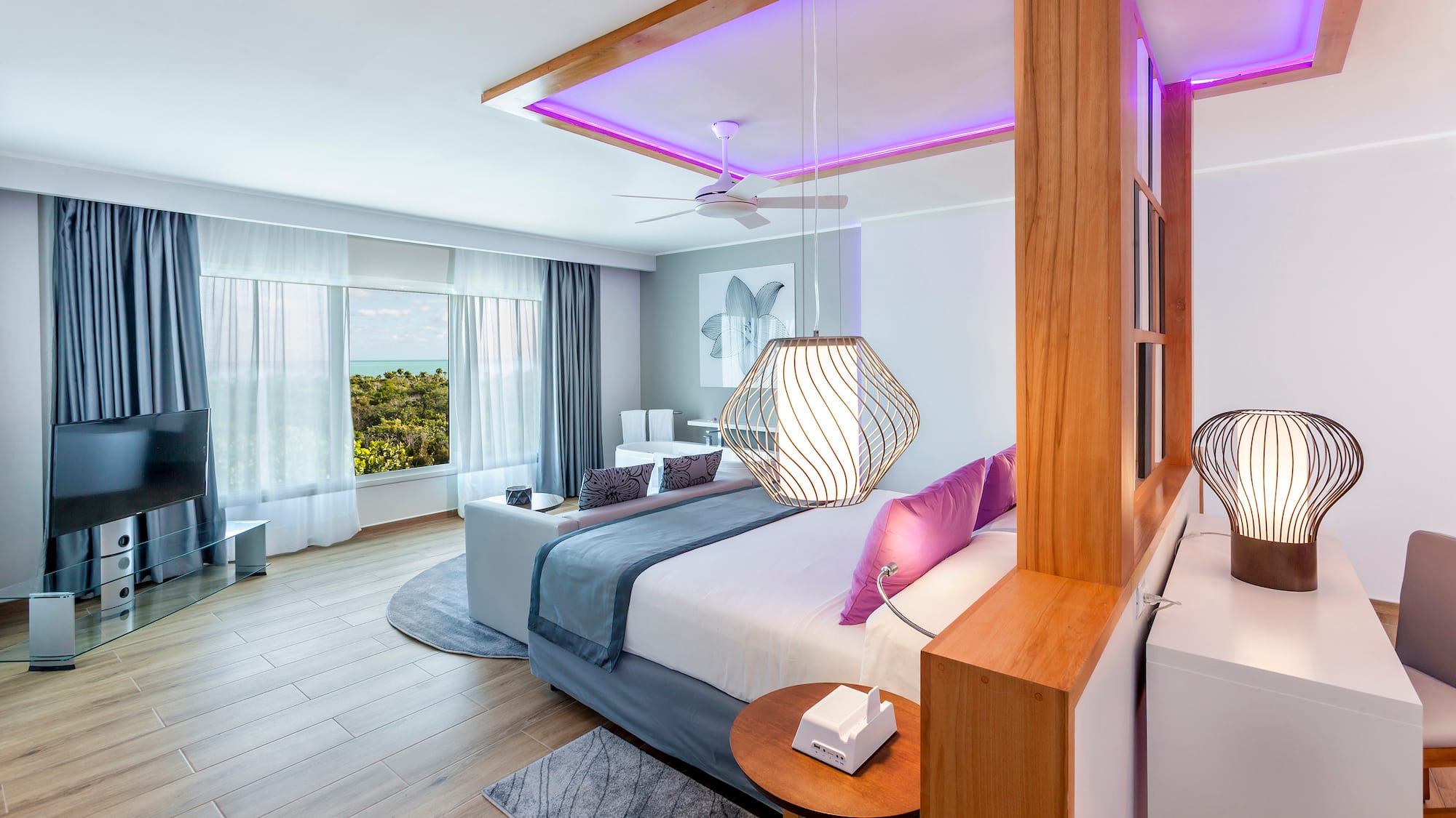 a bedroom with a large bed and a ceiling fan