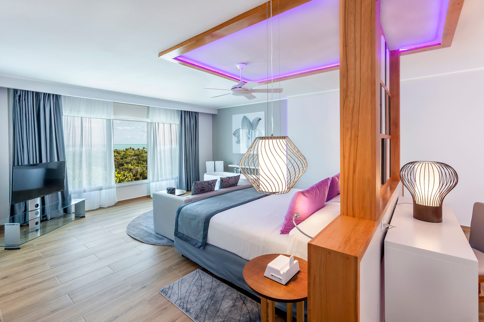 a bedroom with a large bed and a ceiling fan