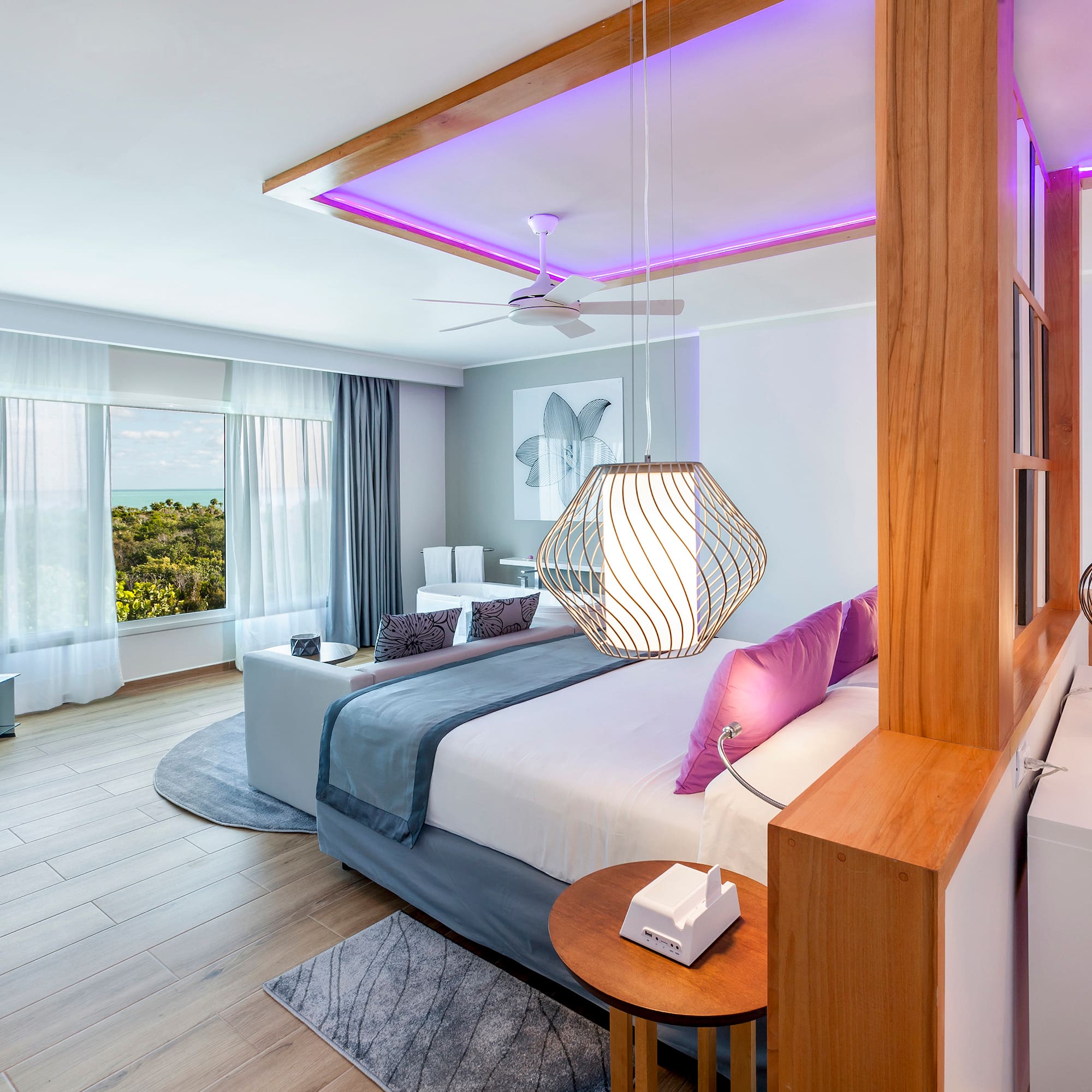 a bedroom with a large bed and a ceiling fan