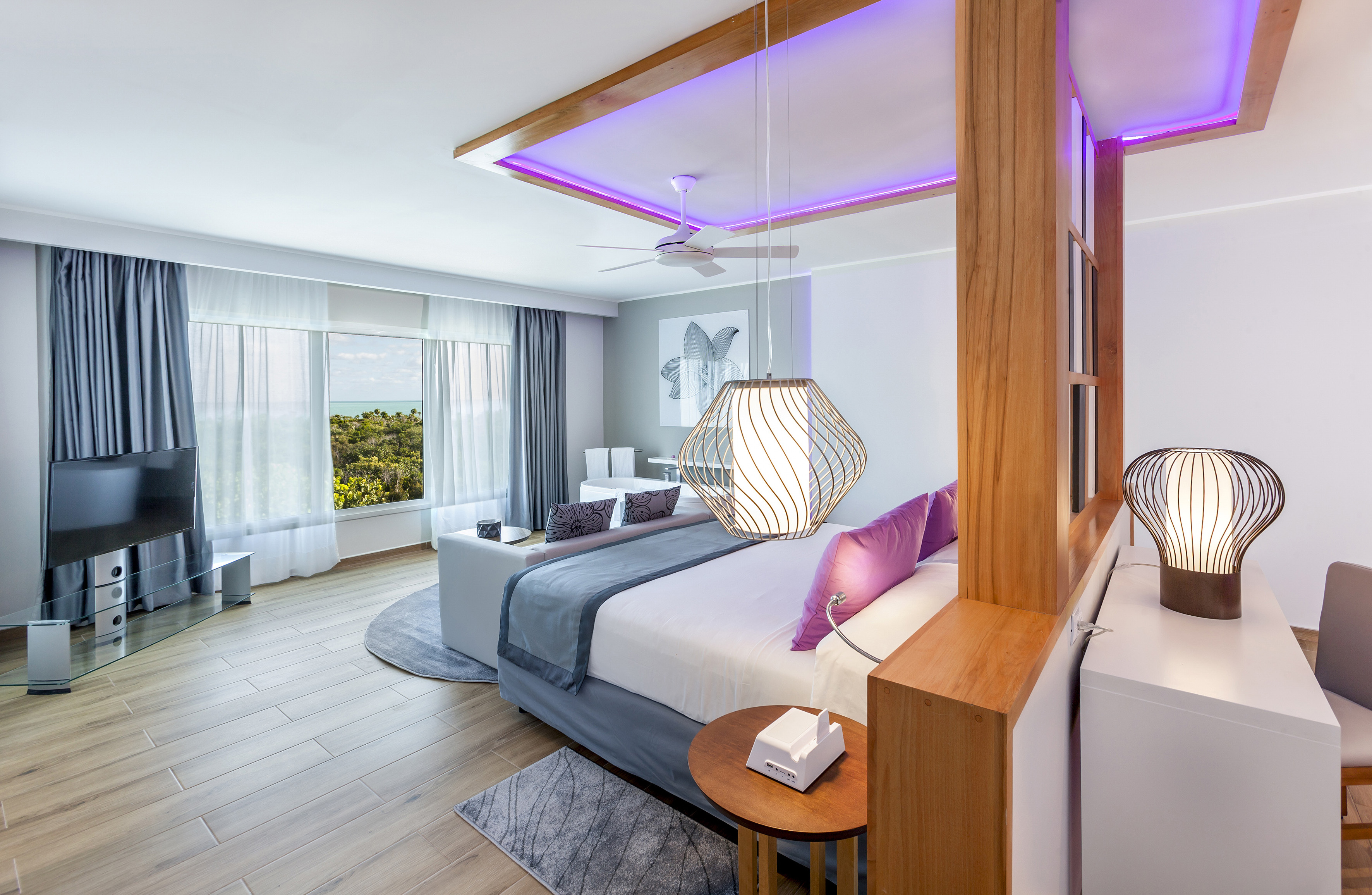 a bedroom with a large bed and a ceiling fan