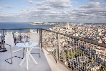 a table and chair overlooking a city