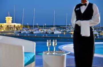 a waiter standing in front of a marina