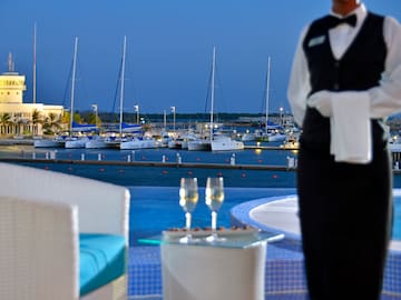 a waiter standing in front of a marina