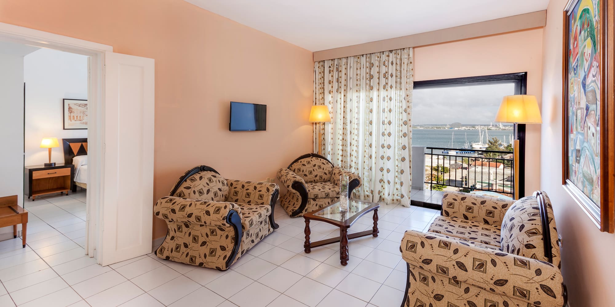 a living room with a television and chairs