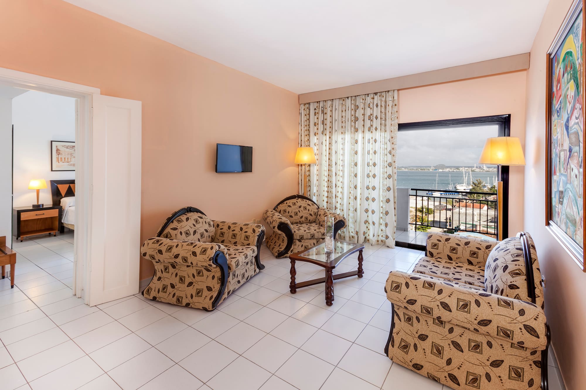 a living room with a television and chairs