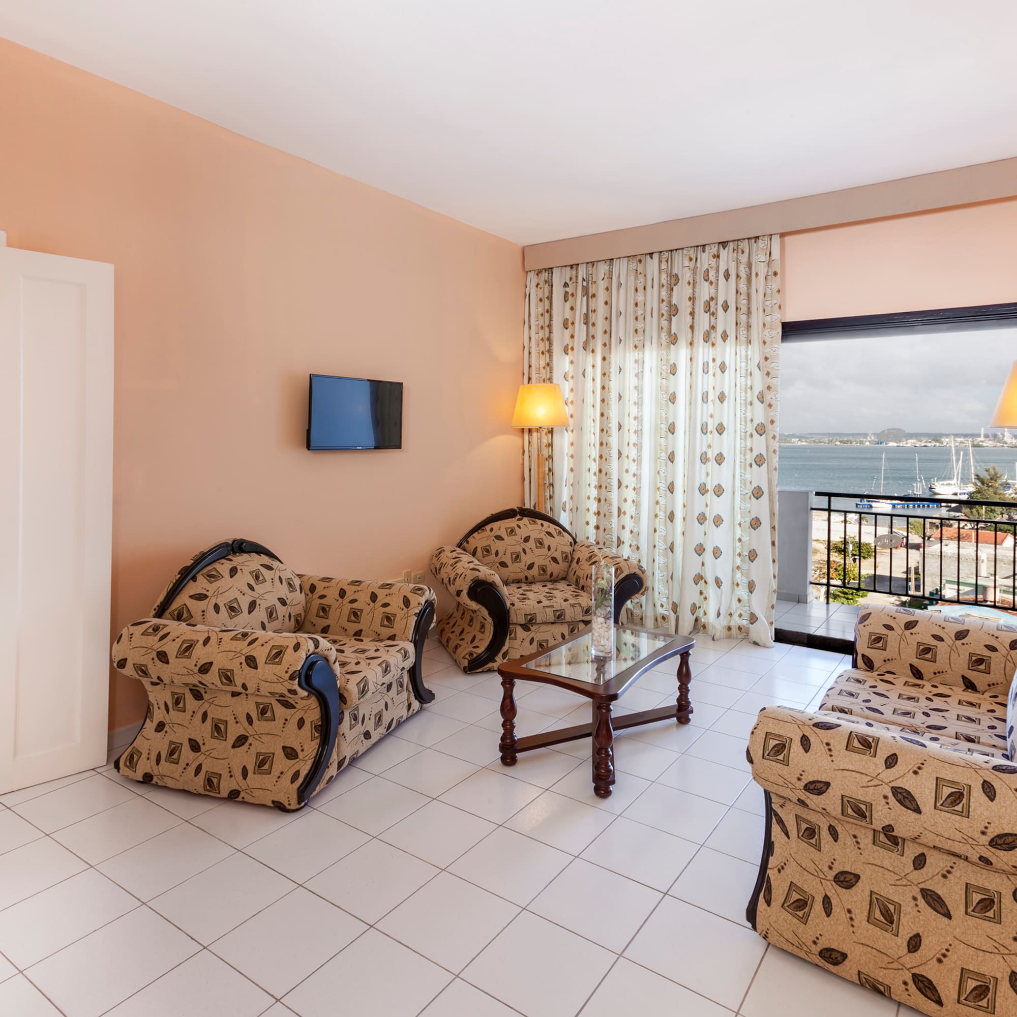 a living room with a television and chairs