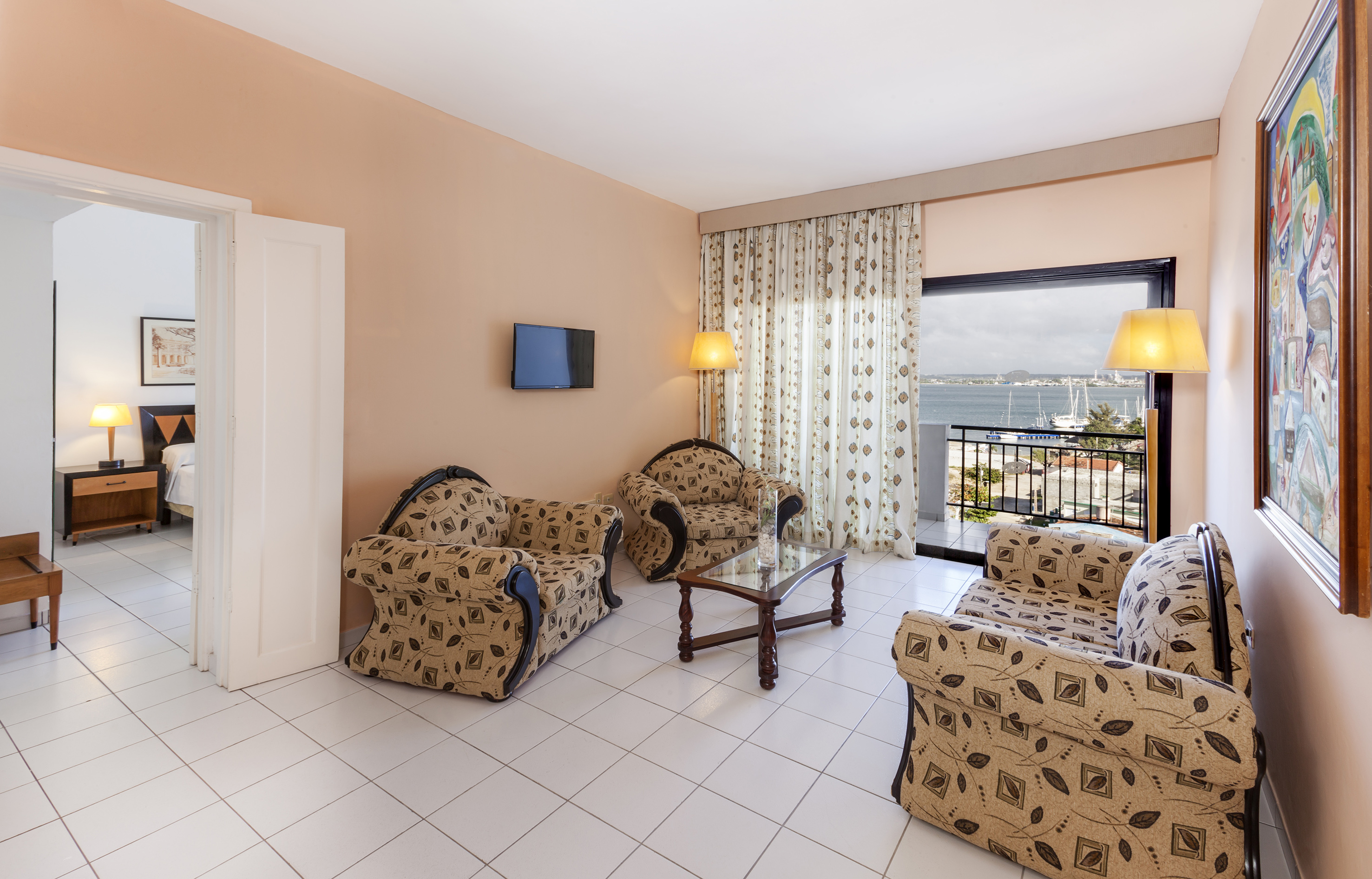 a living room with a television and chairs