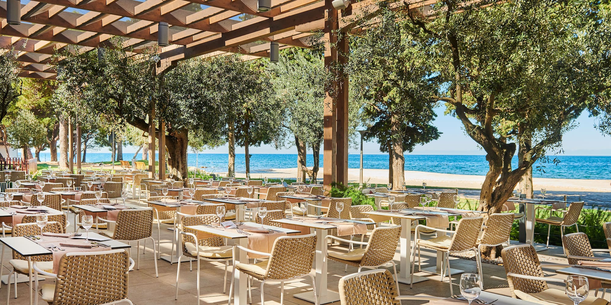 a restaurant with tables and chairs under a canopy